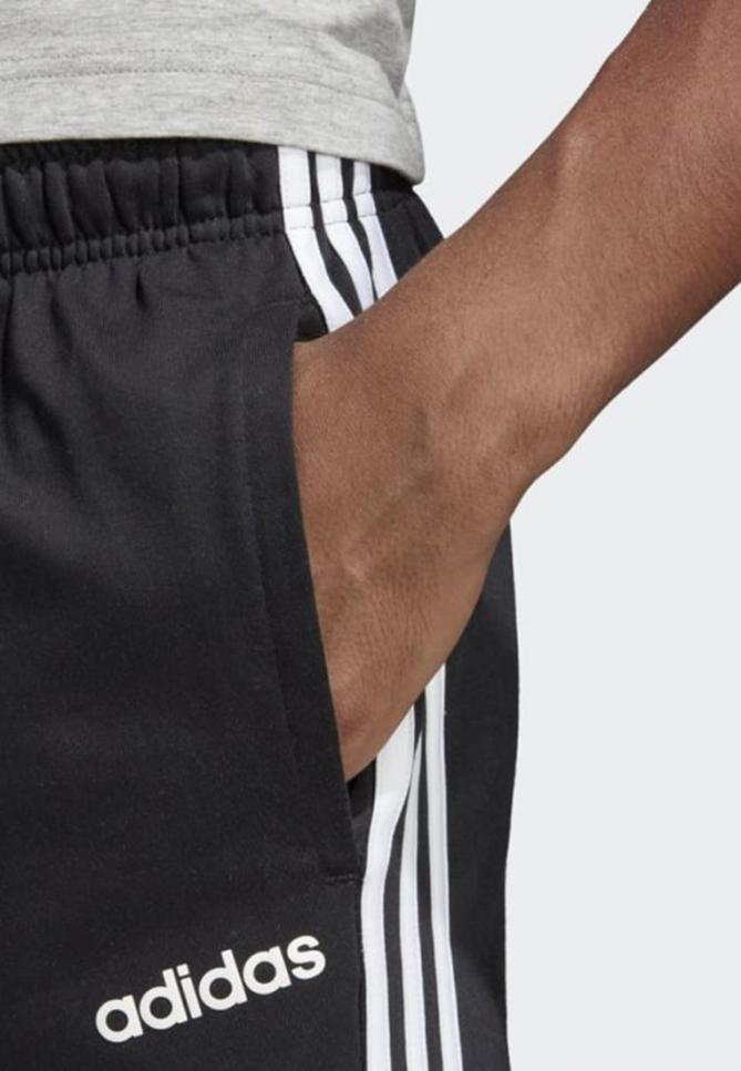 Pantaloni | ESSENTIALS 3-STRIPES TAPERED OPEN HEM PANTS Black | adidas Performance Uomo